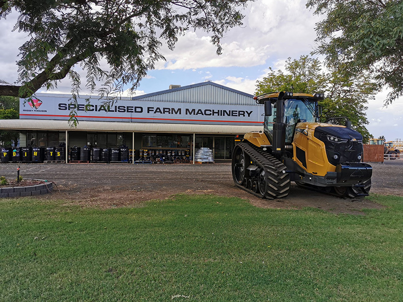 Specialised Farm Machinery building, yellow tractor out the front the the grass